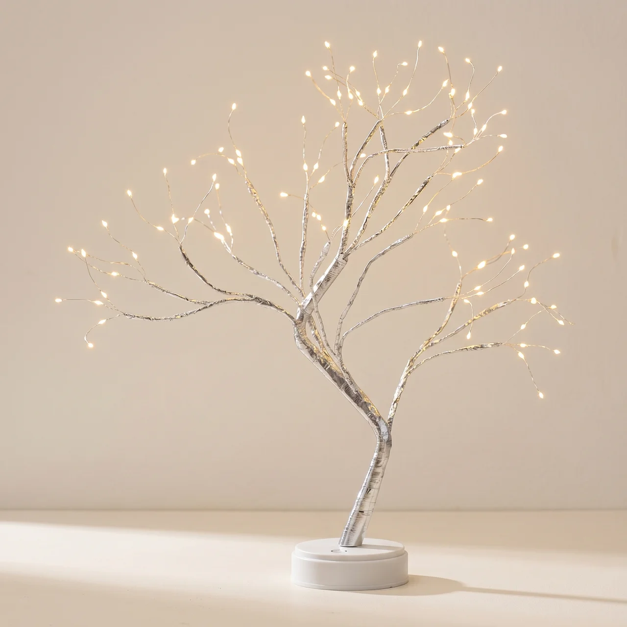 Decorative tree with lights on a plain background