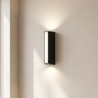 Modern wall-mounted light fixture on a neutral wall