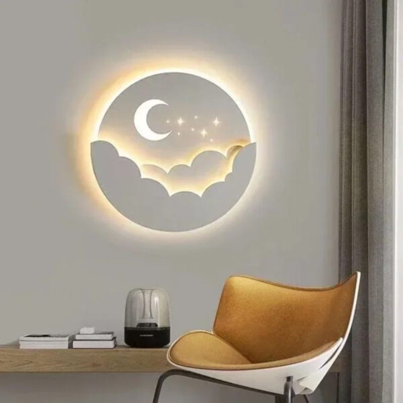 Decorative wall light with moon and cloud design on a wall above a table and chair.