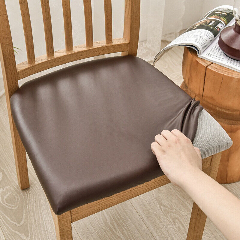 Brown chair pad being placed on a wooden chair with a wooden table and magazine in the background.