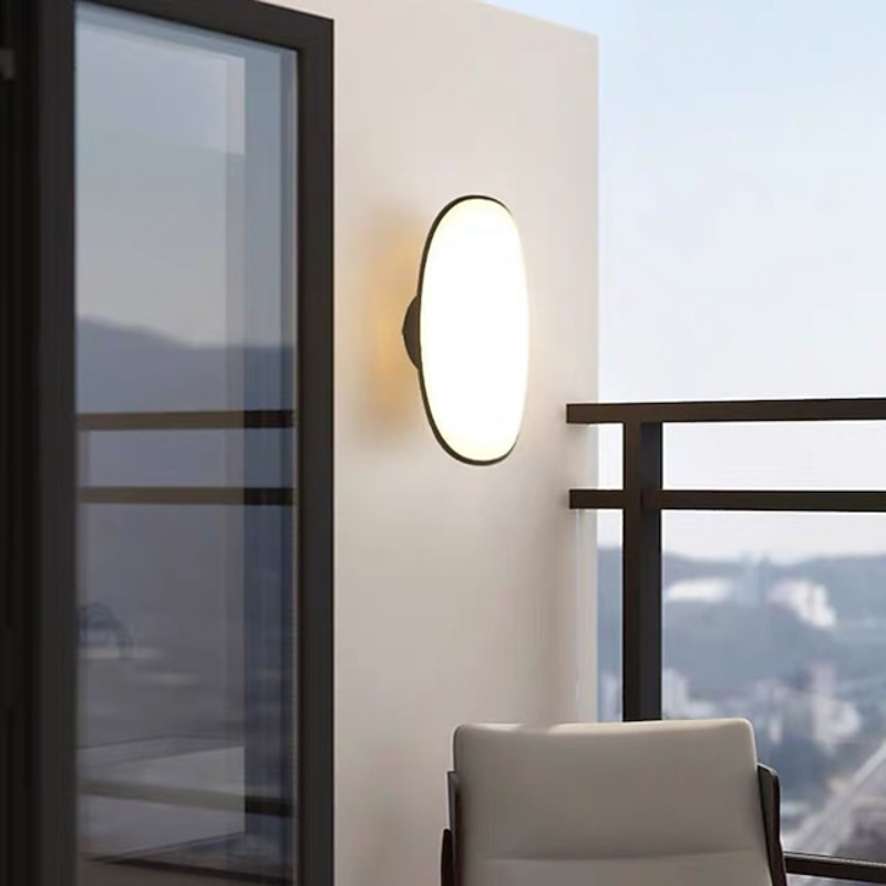 Modern wall-mounted light fixture on a wall with a scenic view outside.