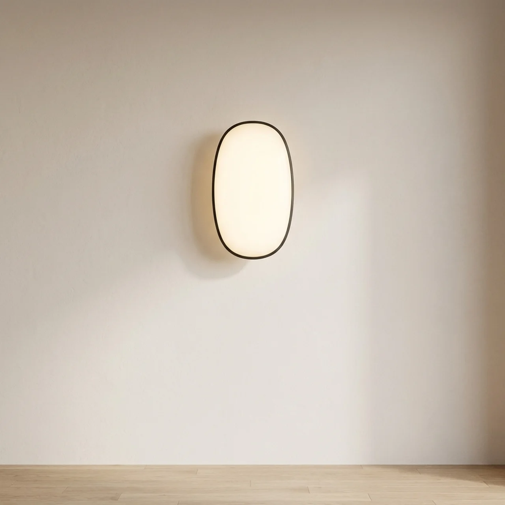 Modern wall light fixture on a plain wall with a neutral color palette.