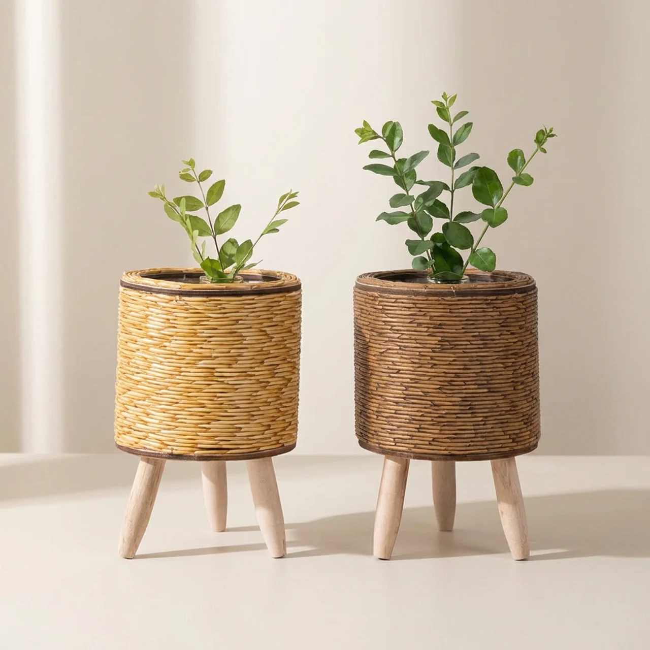 Two wicker planters with plants on a plain background