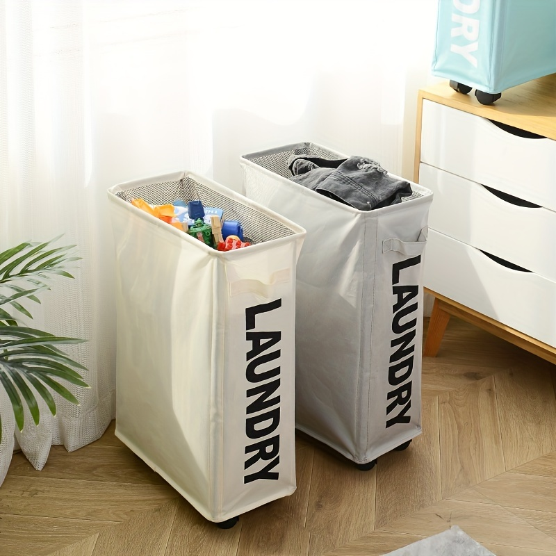Two laundry baskets labeled 'LAUNDRY' in a room with a plant and dresser.