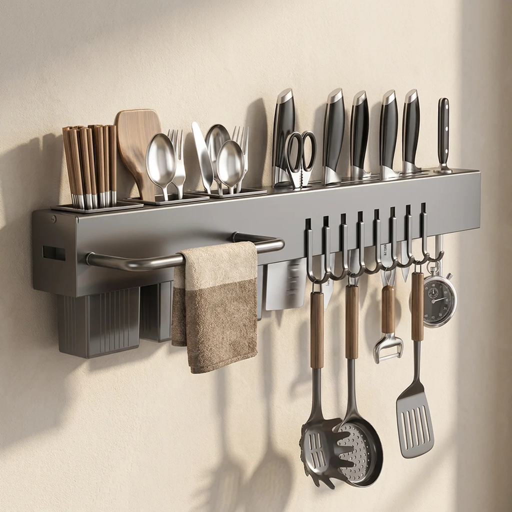 Wall-mounted kitchen utensil holder with various tools on a beige wall.