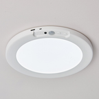 Round ceiling light fixture with sensor on a white ceiling