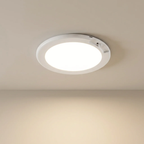 Round ceiling light fixture on a beige ceiling