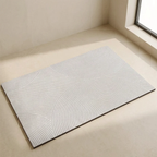 Textured rug on a beige floor with a window in the background