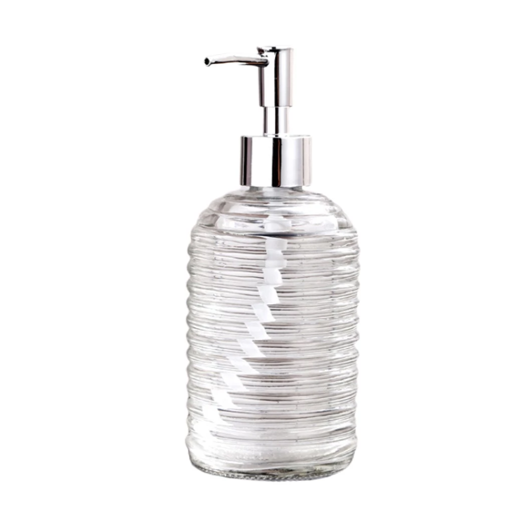 Clear glass soap dispenser with silver pump on a white background