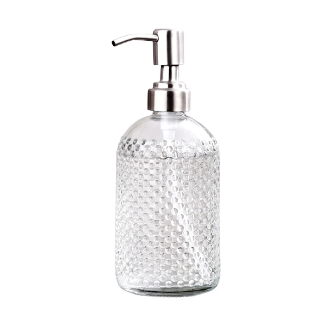 Clear glass soap dispenser with silver pump on a white background