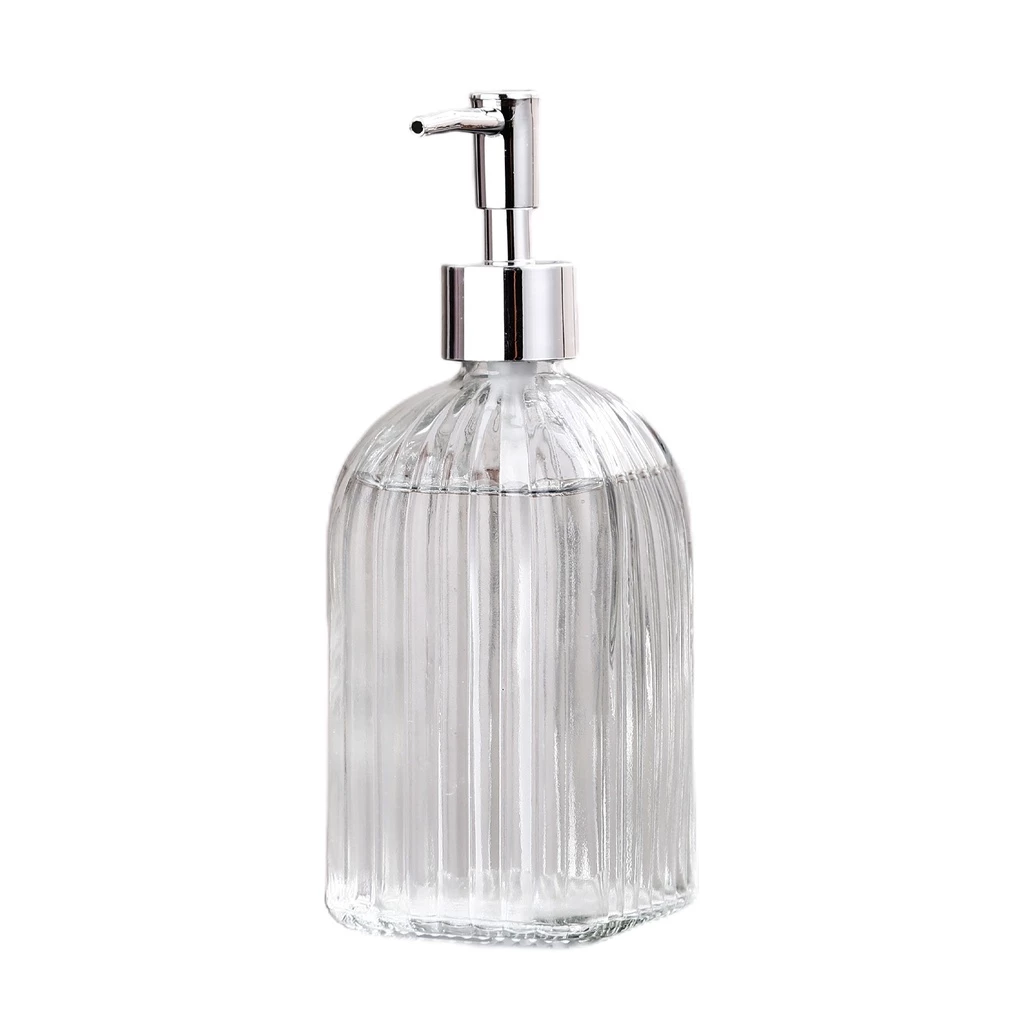 Clear glass soap dispenser with silver pump on a white background