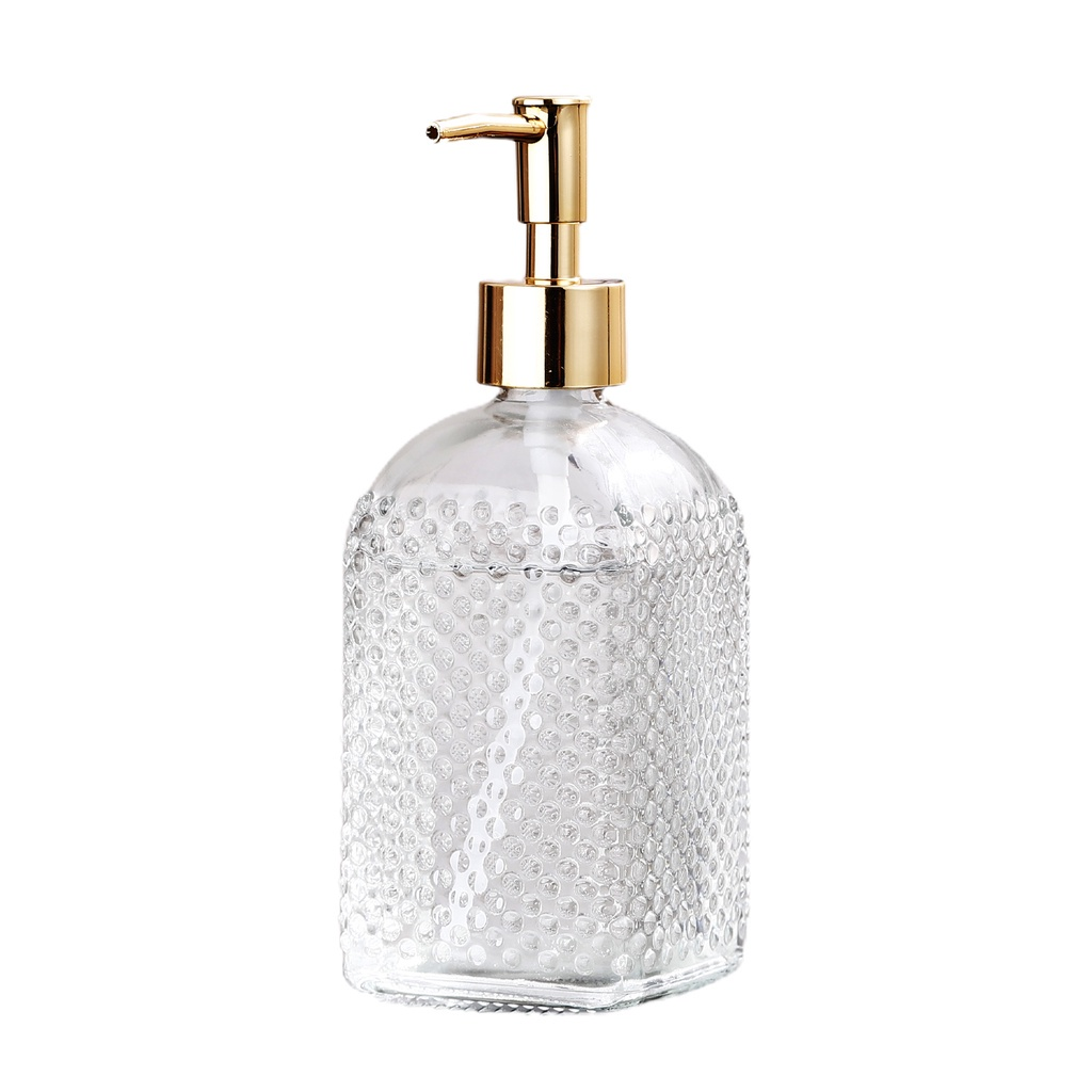 Clear glass soap dispenser with gold pump on a white background