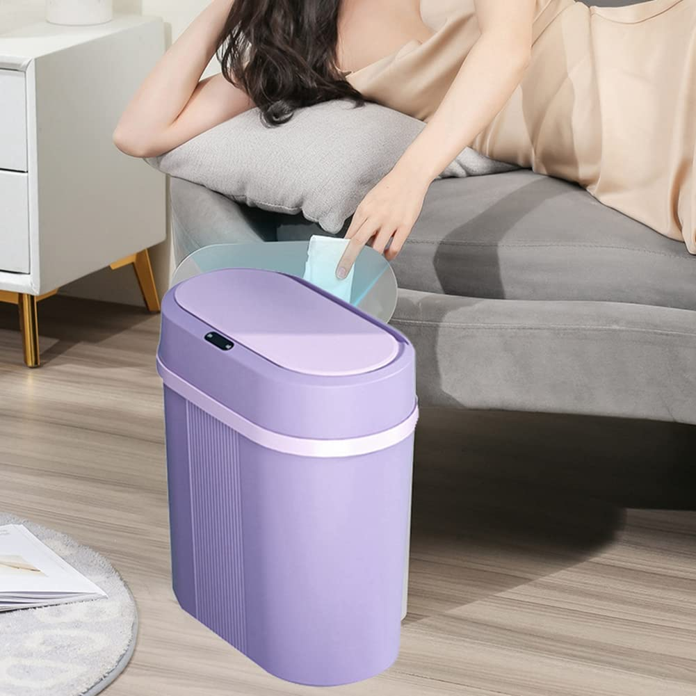 Purple trash bin on a wooden floor with a person sitting on a couch in the background.