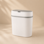 White trash bin with gray lid on a beige background