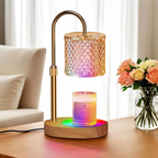 Decorative lamp with colorful light effects on a wooden base, placed on a table with a vase of flowers in the background.