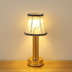 Table lamp with a decorative shade on a wooden surface