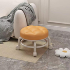 Round orange stool with wheels in a room setting