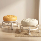 Two round stools with cushioned tops on wheels in a room setting.