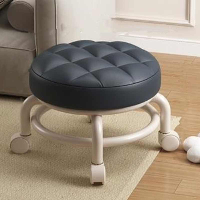 Round cushioned stool with wheels on a carpeted floor.