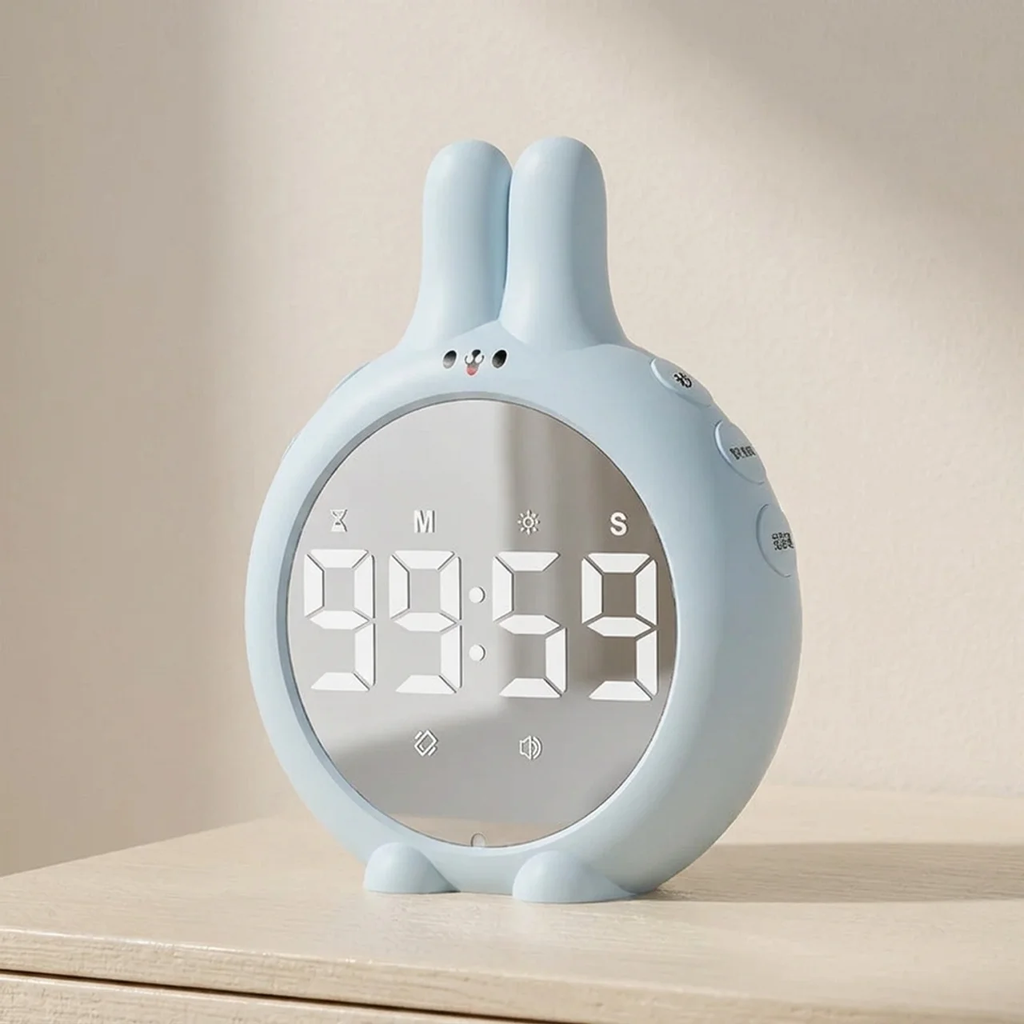 Light blue rabbit-shaped clock with digital display on a wooden surface