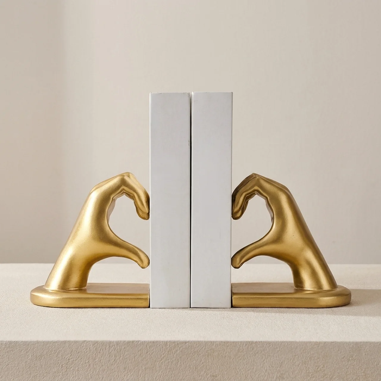 Gold horse head bookends on a neutral background