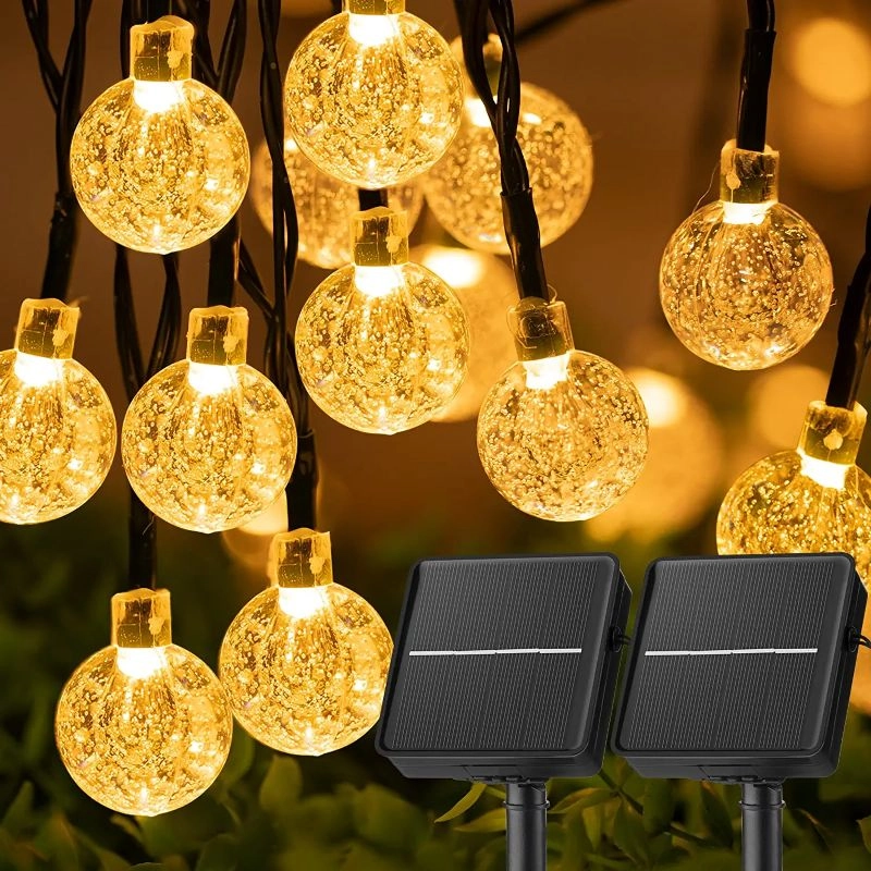 String of decorative lights with solar panels on a blurred background