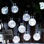 String of decorative light bulbs with a solar panel on a dark background