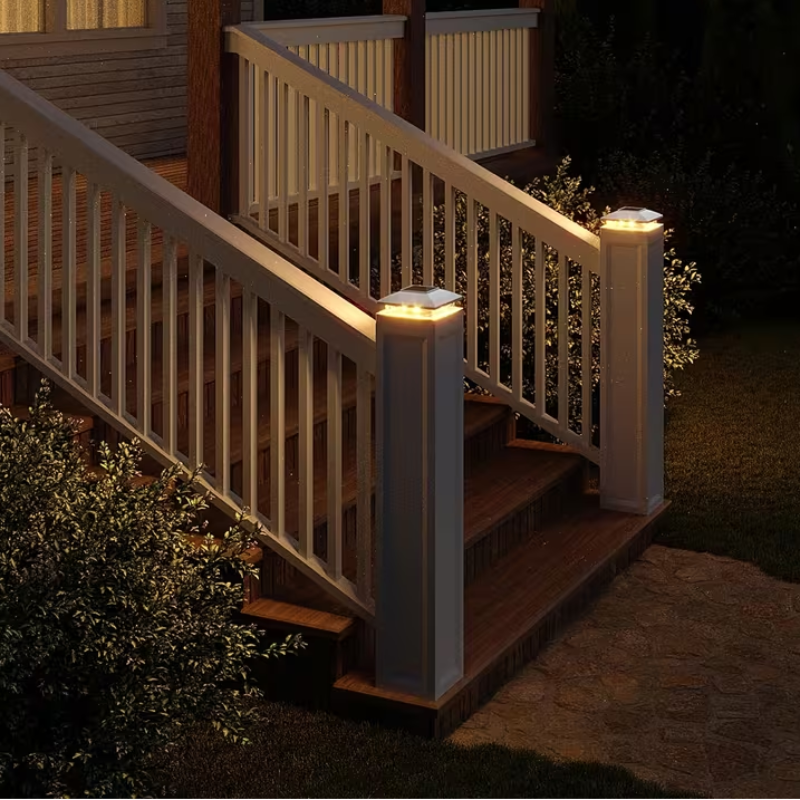 Outdoor staircase with illuminated railings and steps at night.