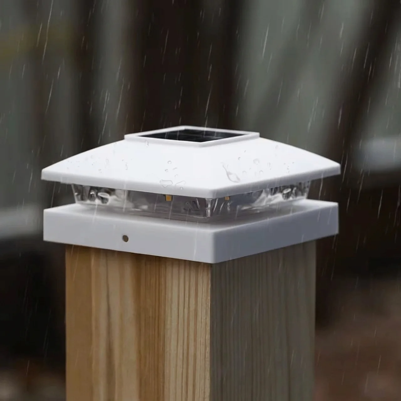 Solar post cap light on a wooden post with raindrops in the background