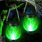 Two green glowing lanterns with a spooky hand and spider web in the background.