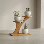 Wooden plant stand with three potted plants on a neutral background