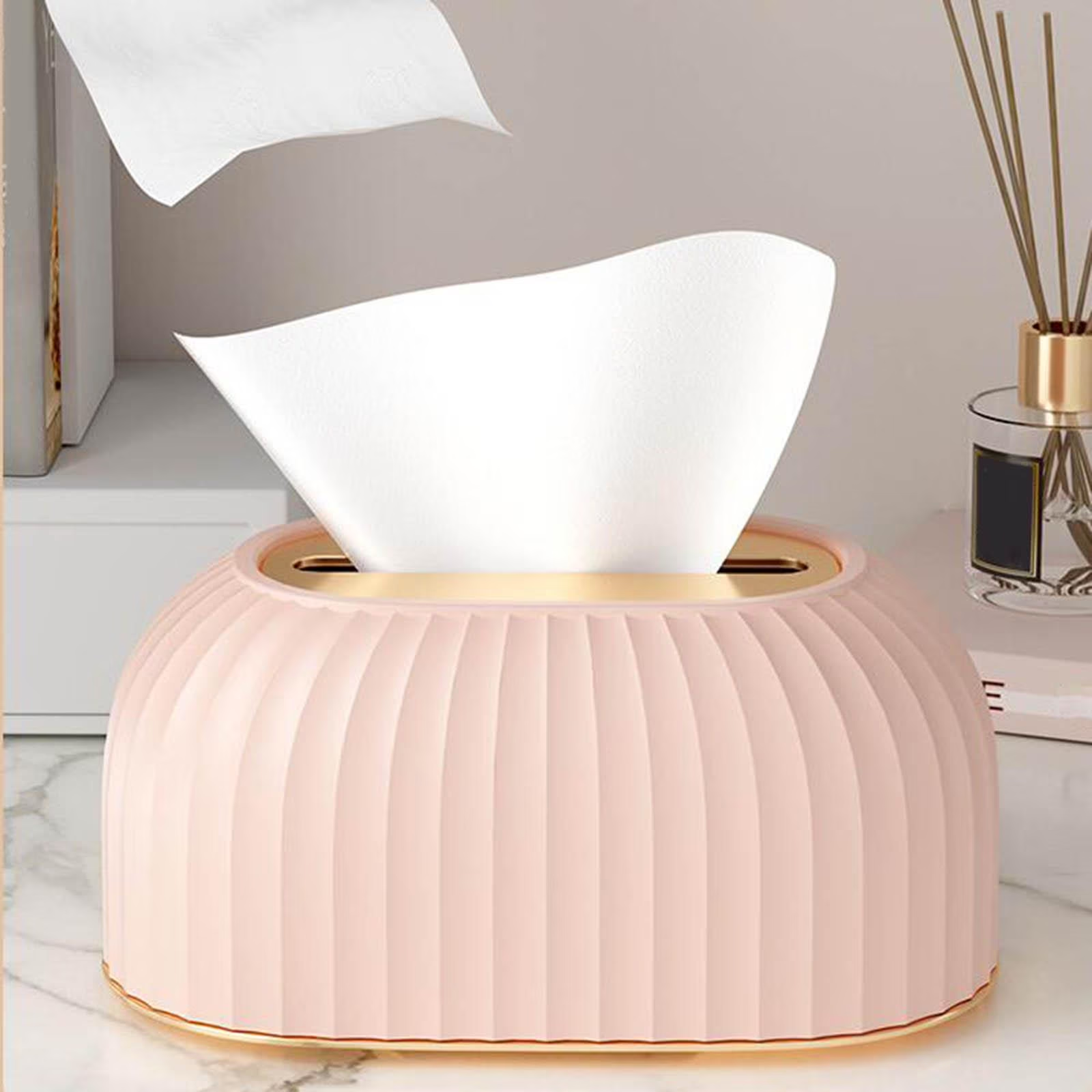 Pink and white decorative lamp on a marble surface with a blurred background
