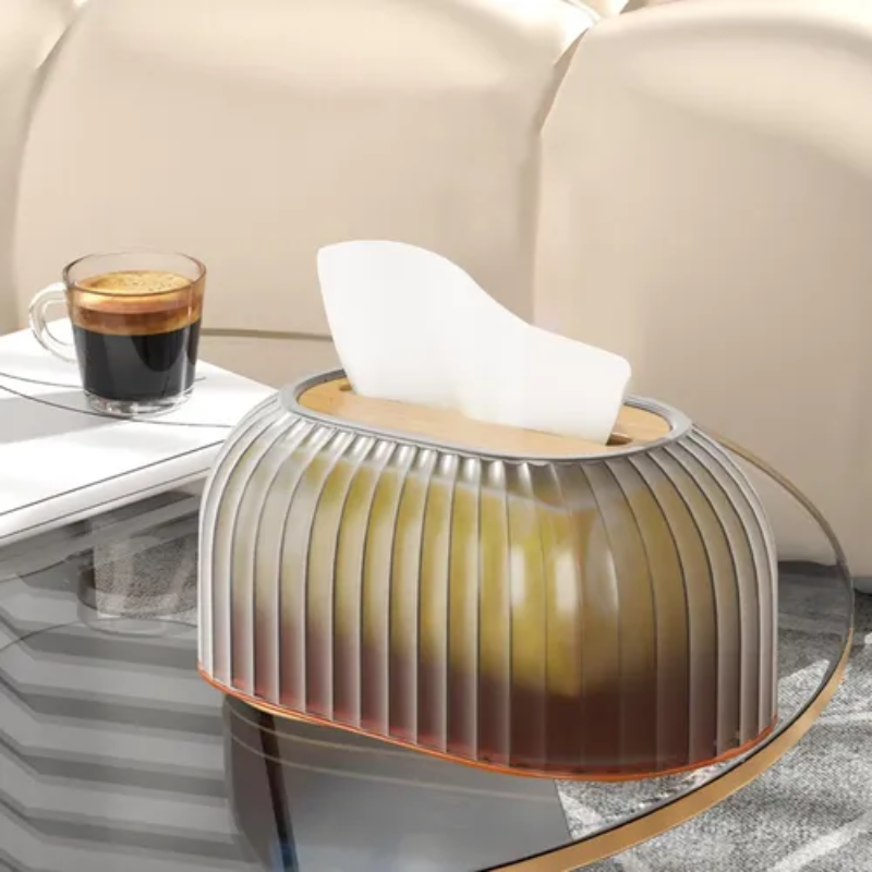 Modern glass side table with a white lamp and coffee on a glass surface.