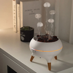 White diffuser with wooden legs on a surface, emitting mist.
