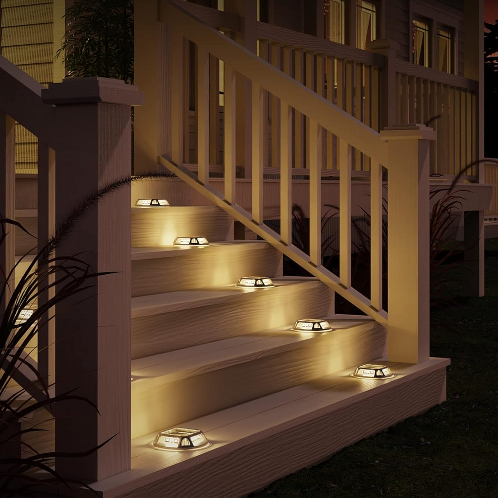 Stair lights illuminating a set of outdoor steps at night.