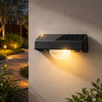 Solar-powered outdoor wall light fixture on a wall with garden in the background