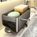 A stainless steel bathroom sink soap dispenser holder with a water-filling feature, shown on a sink with soap bars and a sponge inside.
