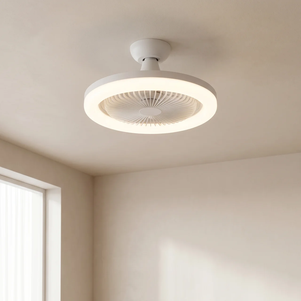 A modern white ceiling fan light with a circular LED ring, mounted on a beige ceiling in a minimalist room.