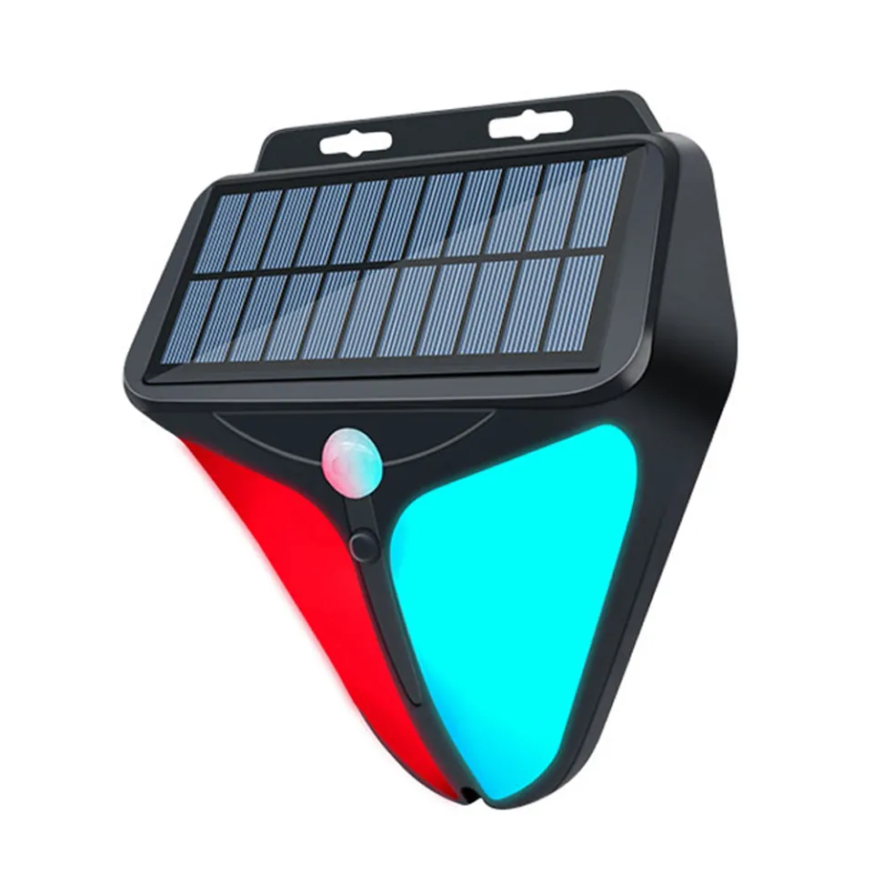 A solar-powered outdoor security light with a black plastic housing, a blue solar panel on top, a red and cyan LED light panel, and a small motion sensor button.