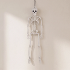 A hanging white plastic skeleton decoration with a black hanging loop at the top, shown against a plain off-white wall.