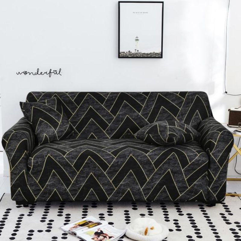 Sofa with a black geometric pattern in a room with a white wall and a small table.
