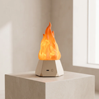 A modern low-poly base lamp with a glowing orange and yellow flame effect, sitting on a light gray stone pedestal in a minimalist interior setting.