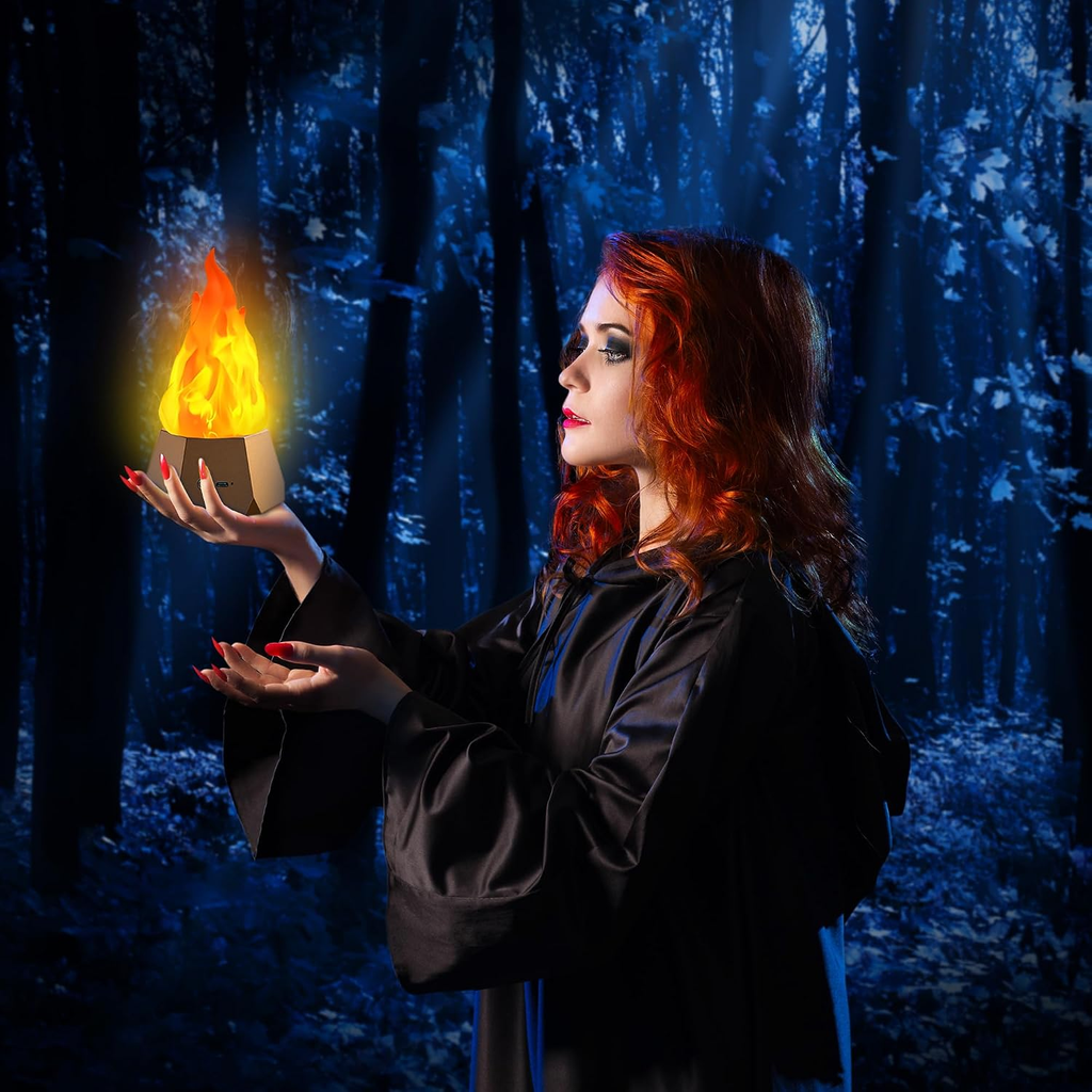A woman with red hair wearing a black robe stands in a dark blue forest, holding a glowing yellow-orange flame-like orb in her hands.
