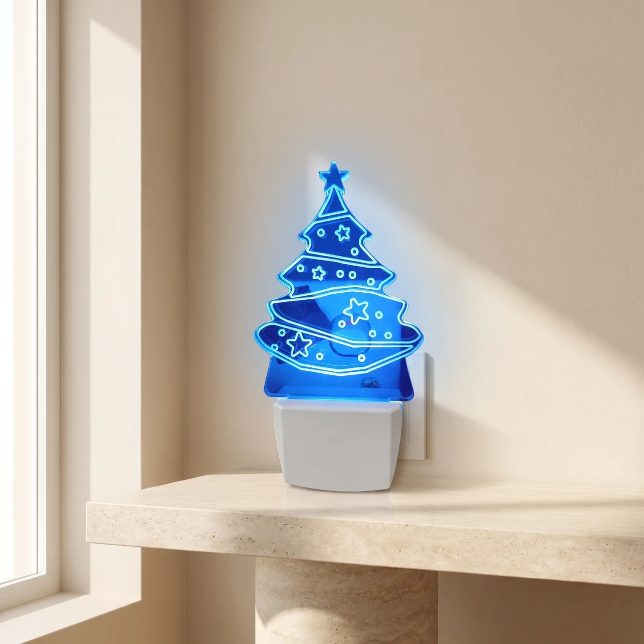 A blue LED night light shaped like a Christmas tree glowing on a white base, placed on a beige stone shelf against a beige wall near a window.