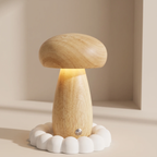 A mushroom-shaped wooden night light with a warm glowing light, resting on a white scalloped wooden base against a beige background.