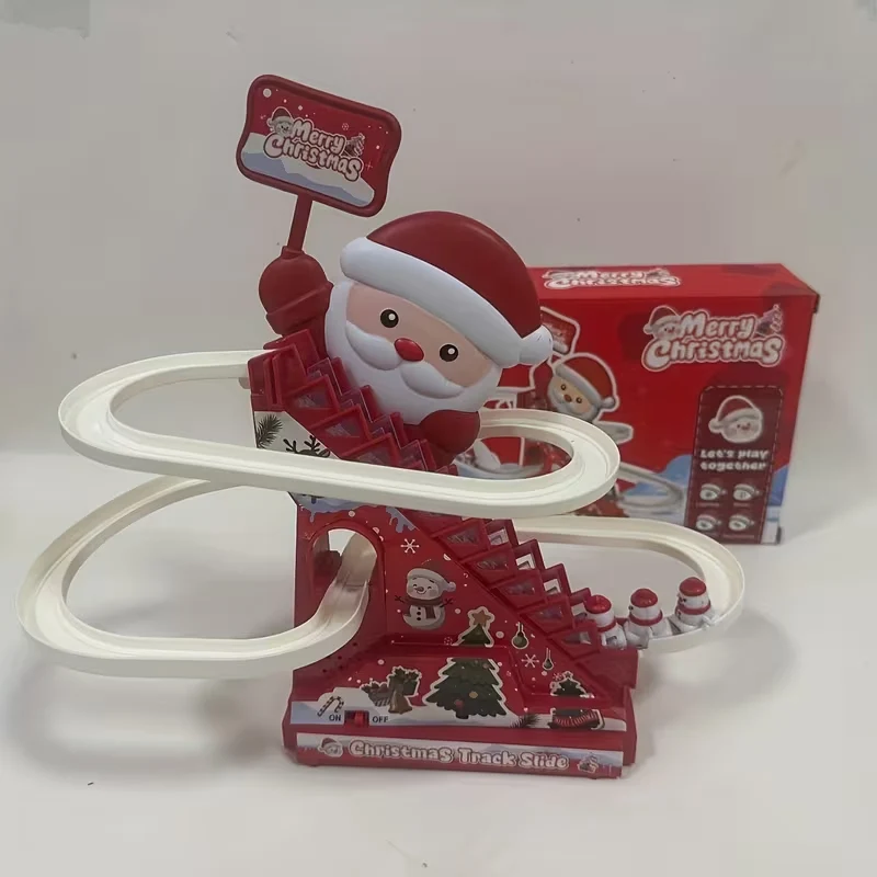 A Christmas-themed toy track slide with a red Santa-themed base, white curved plastic track loops, and a red retail box behind it on a plain light background.