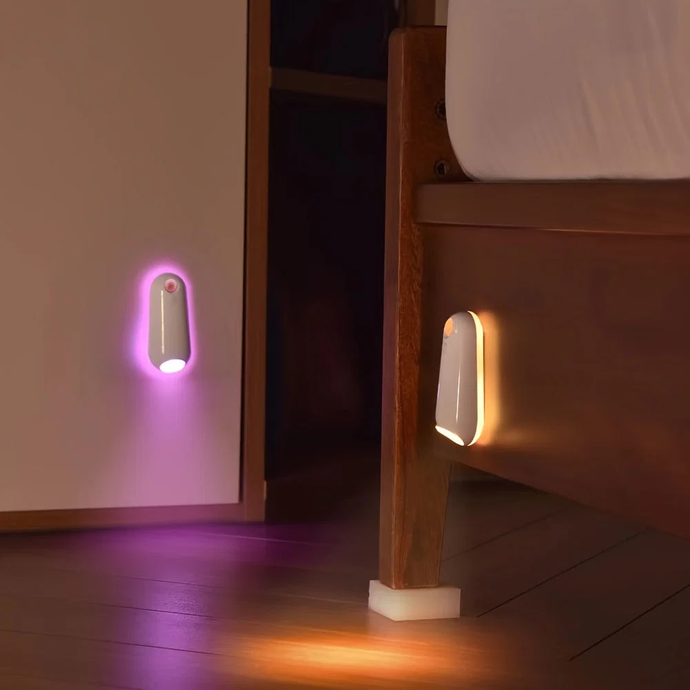 Two night lights on a wall and floor in a dimly lit room.