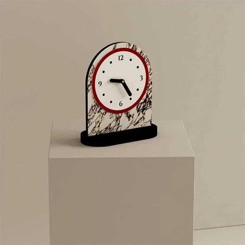 Marble-patterned table clock on a beige pedestal against a beige background