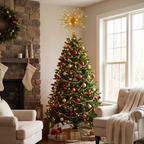 A decorated Christmas tree stands in a cozy living room corner beside a stone fireplace and large window. The tree is lit with warm white lights and adorned with red and gold ornaments, wrapped in gold garland, and topped with a large gold star tree topper.