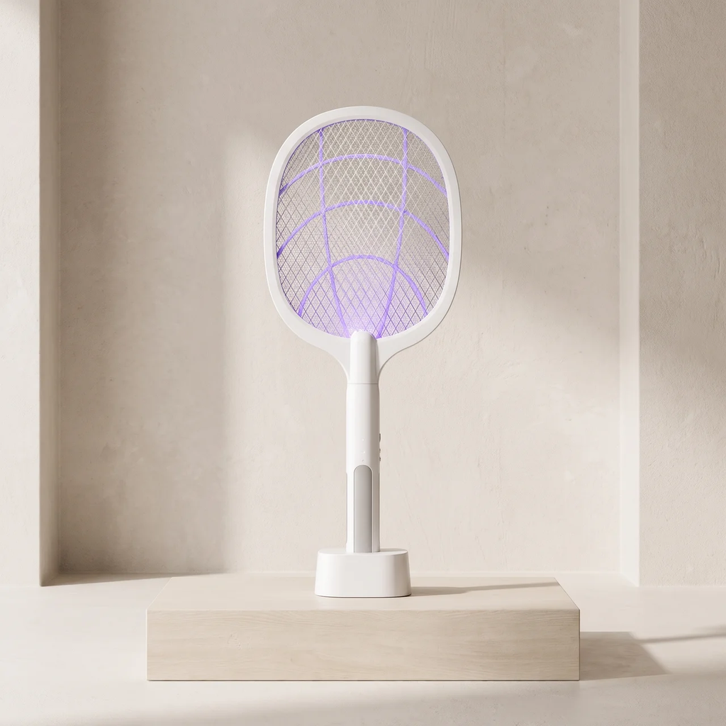 A white electric fly swatter with a glowing purple UV light grid, standing on a light wood pedestal against a minimalist beige wall.